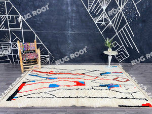 Moroccan Artistry | Handwoven Azilal Rug with Expressive Figures in Red, Blue, and Black